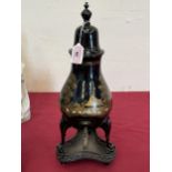 A 19th Century toleware coffee urn on stand, painted in gilt with a landscape. 17½" high.