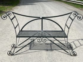 A wrought iron garden seat with slatted seat. 65" wide.