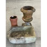 A sandstone sink, 21½" wide; a terracotta campana garden vase (AF) and a terracotta pot.