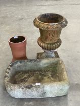 A sandstone sink, 21½" wide; a terracotta campana garden vase (AF) and a terracotta pot.