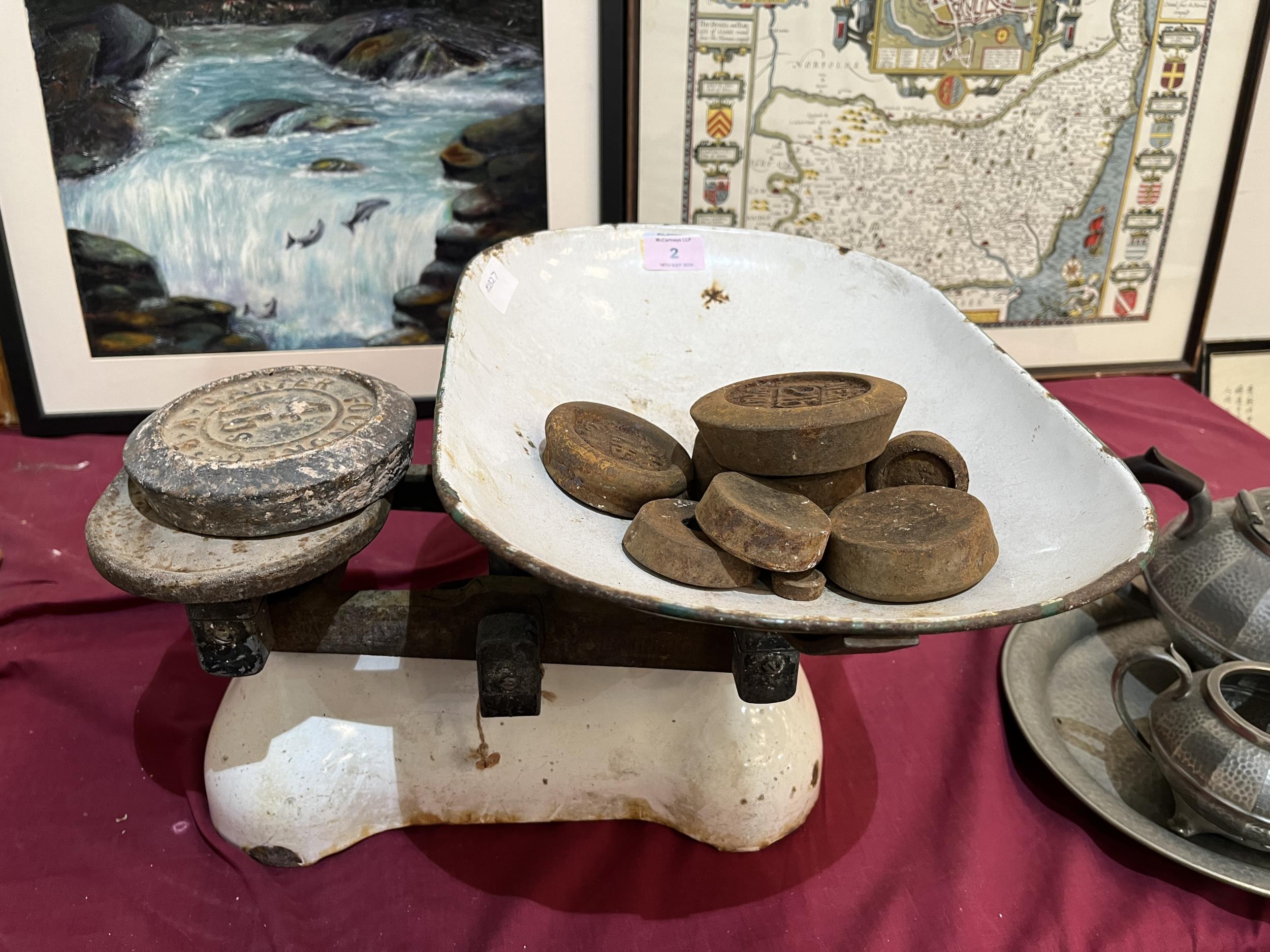 A set of weighing scales and weights.
