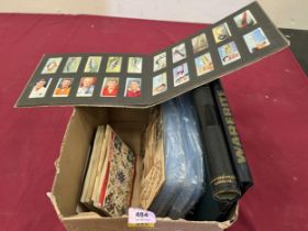 A box of cigarette and teacards, postcards and a Simplex-de-Luxe stamp album.