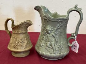 Two Victorian jugs with moulded relief decoration, the drab glazed example by Ridgway. 9" high and