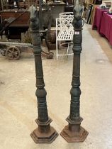 A pair of cast iron posts with horse head terminals. 54" high.