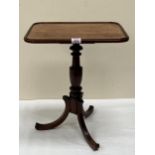 A Victorian mahogany kettle stand on tripod support. 17" wide.