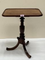 A Victorian mahogany kettle stand on tripod support. 17" wide.