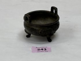 A Chinese bronze censer with two handles, moulded decoration and raised on three elephant head feet.