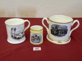 A 19th Century loving cup and two mugs, all transfer printed with views of Malvern or Shropshire.