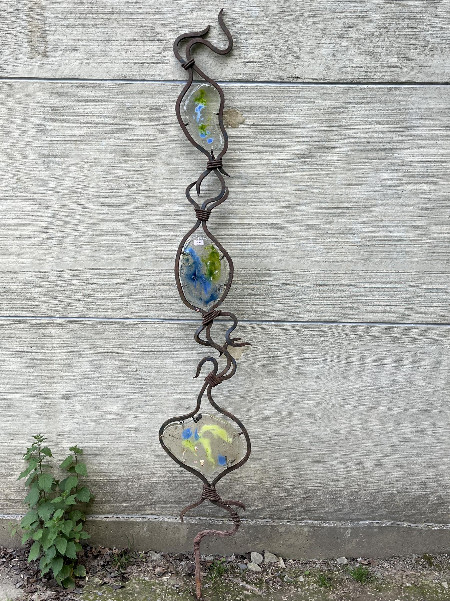 A wrought iron and glass garden ornament 99" high.