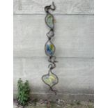 A wrought iron and glass garden ornament 99" high.