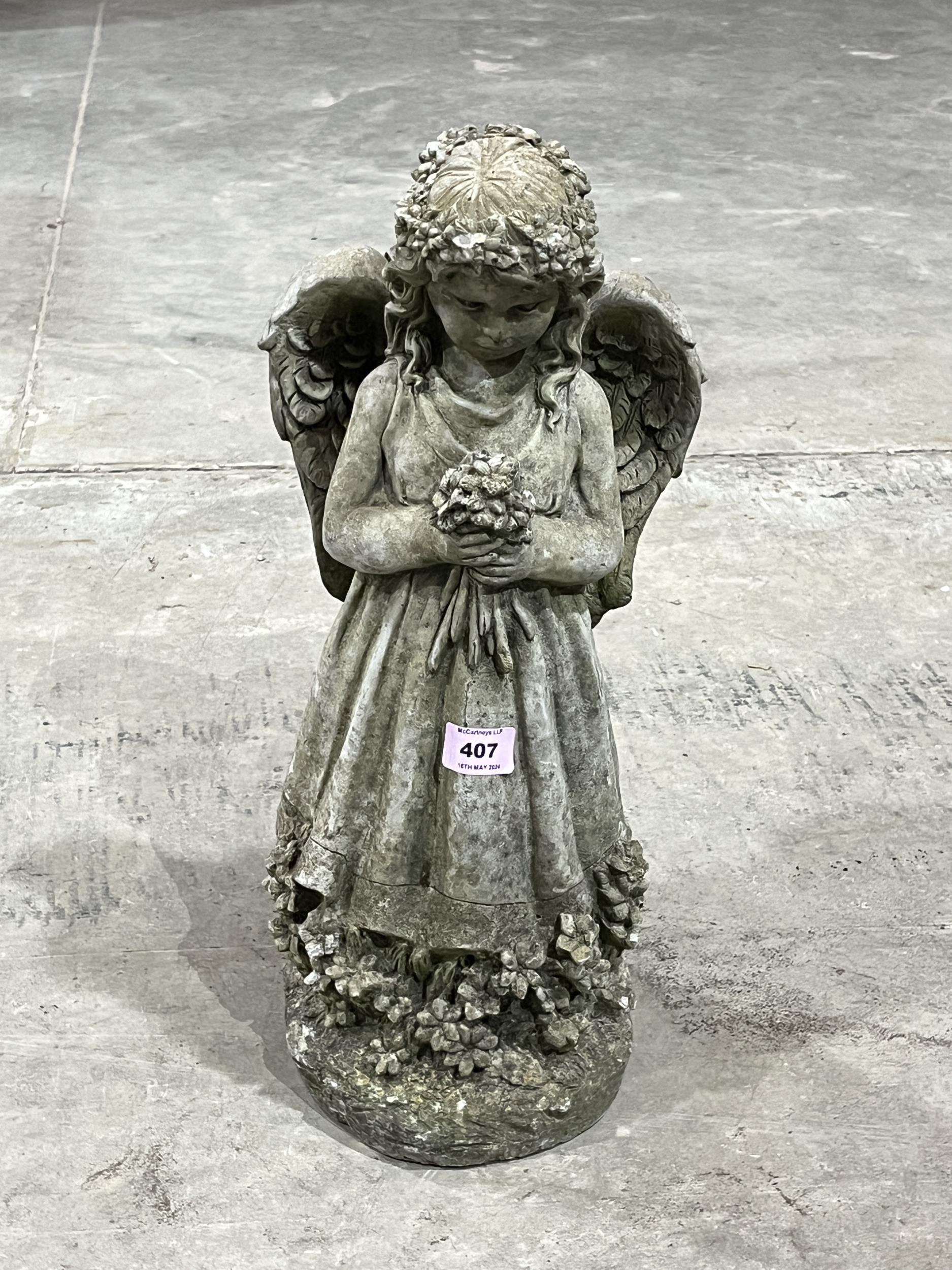 A garden statuary angel ornament. 18" high.