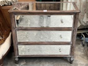 A decorated chest of drawers with mirror plates to top, sides and drawer fronts. 33" wide. Crack