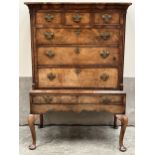 A George II walnut chest on stand, with three short over three long graduated drawers flanked by