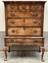 A George II walnut chest on stand, with three short over three long graduated drawers flanked by