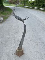 A metal garden ornament of crescent form. 57" high.