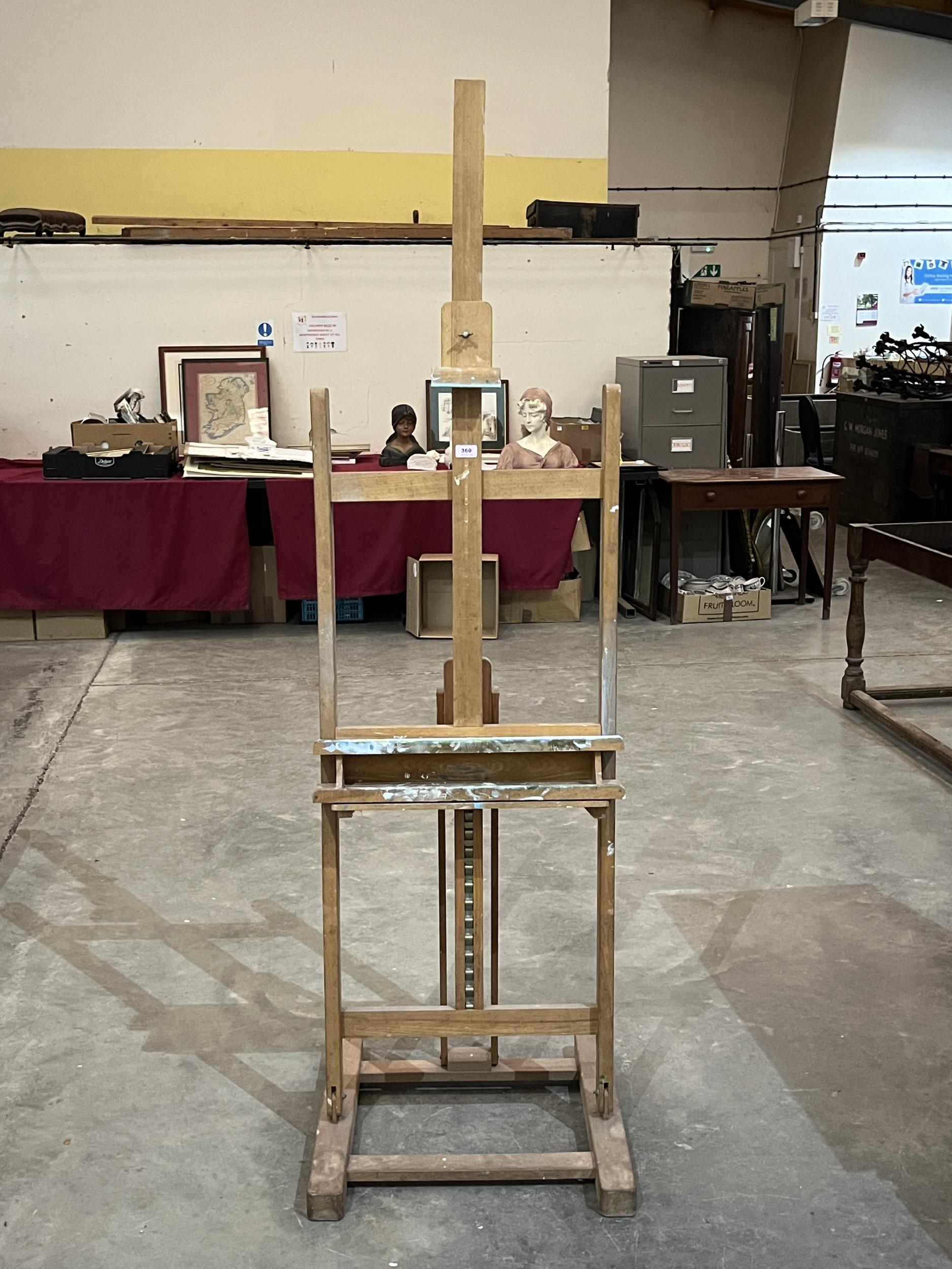 An artist"s studio easel. 77" high.