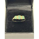 A 9ct emerald and diamond ring. 2g gross. Size R.