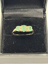A 9ct emerald and diamond ring. 2g gross. Size R.