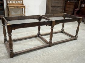 An antique joined oak refectory table base on six baluster turned supports with moulded perimeter