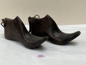 A pair of 19th Century carved treen shoe lasts or moulds. 12" long.