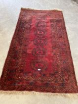 A red ground Eastern rug. 85" x 45".