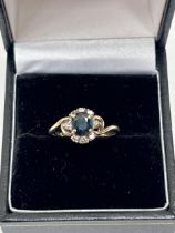 A 9ct sapphire and diamond cluster ring. 2g gross. Size L.