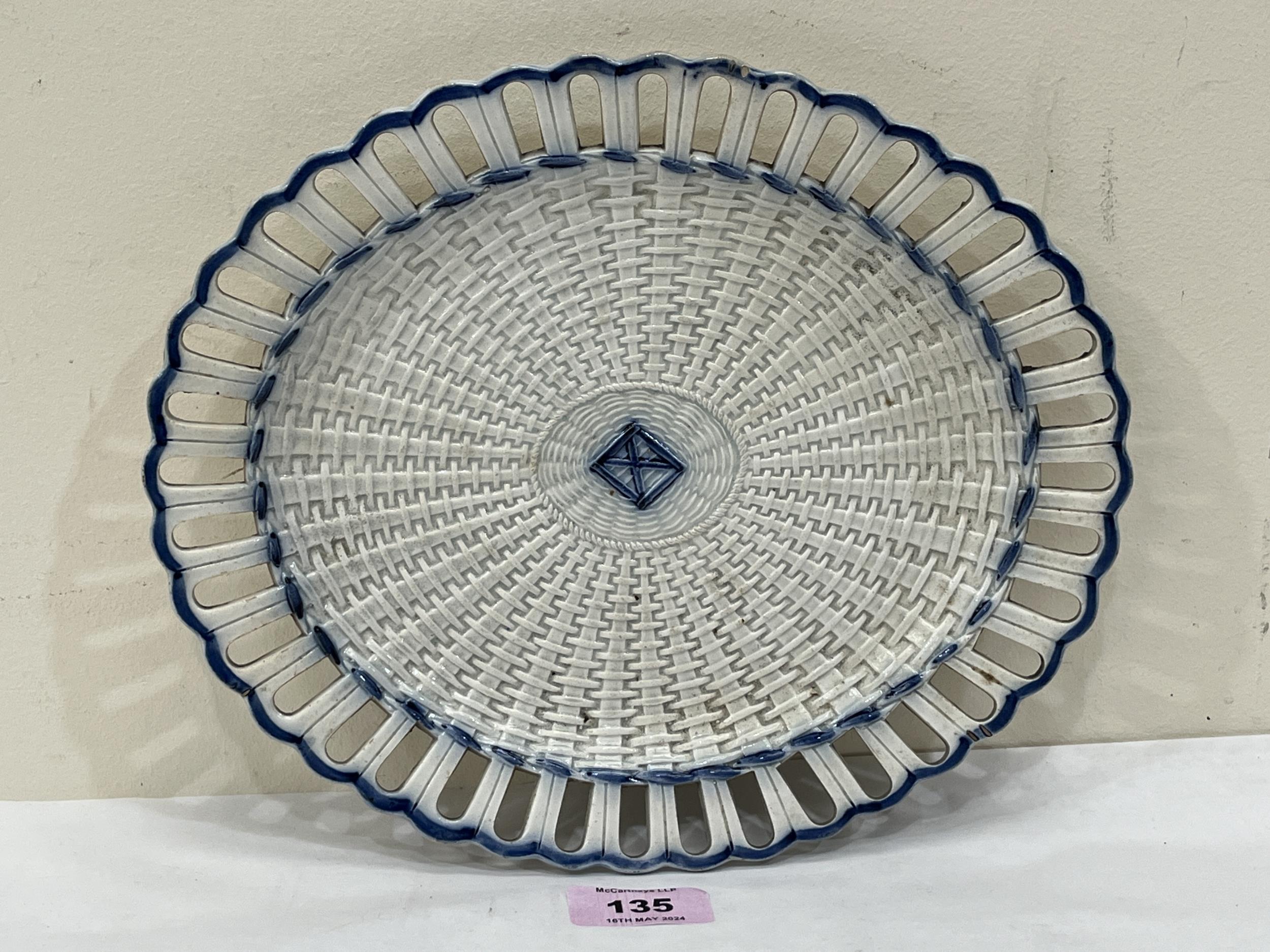 A 19th Century pearlware oval basket weave dish with reticulated rim. 10½" wide. Tiny chip to rim.