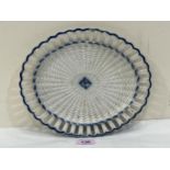 A 19th Century pearlware oval basket weave dish with reticulated rim. 10½" wide. Tiny chip to rim.