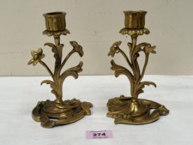 A pair of 19th Century French revived rococo bronze ormolu candlesticks. 6½" high.