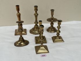 Seven brass candlesticks. 18th Century and later.