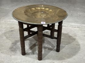 An Indian folding table with brass benares tray top.