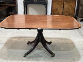 A 19th Century mahogany breakfast table, the crossbanded and line inlaid snap top on a bulbous