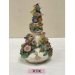 A 19th Century porcelain scent bottle and stopper, encrusted with a profusion of coloured flowers