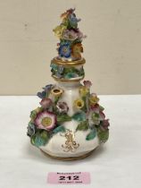 A 19th Century porcelain scent bottle and stopper, encrusted with a profusion of coloured flowers