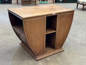 An Art-Deco oak centre table fitted with two fall front music or magazine racks. 28" wide.