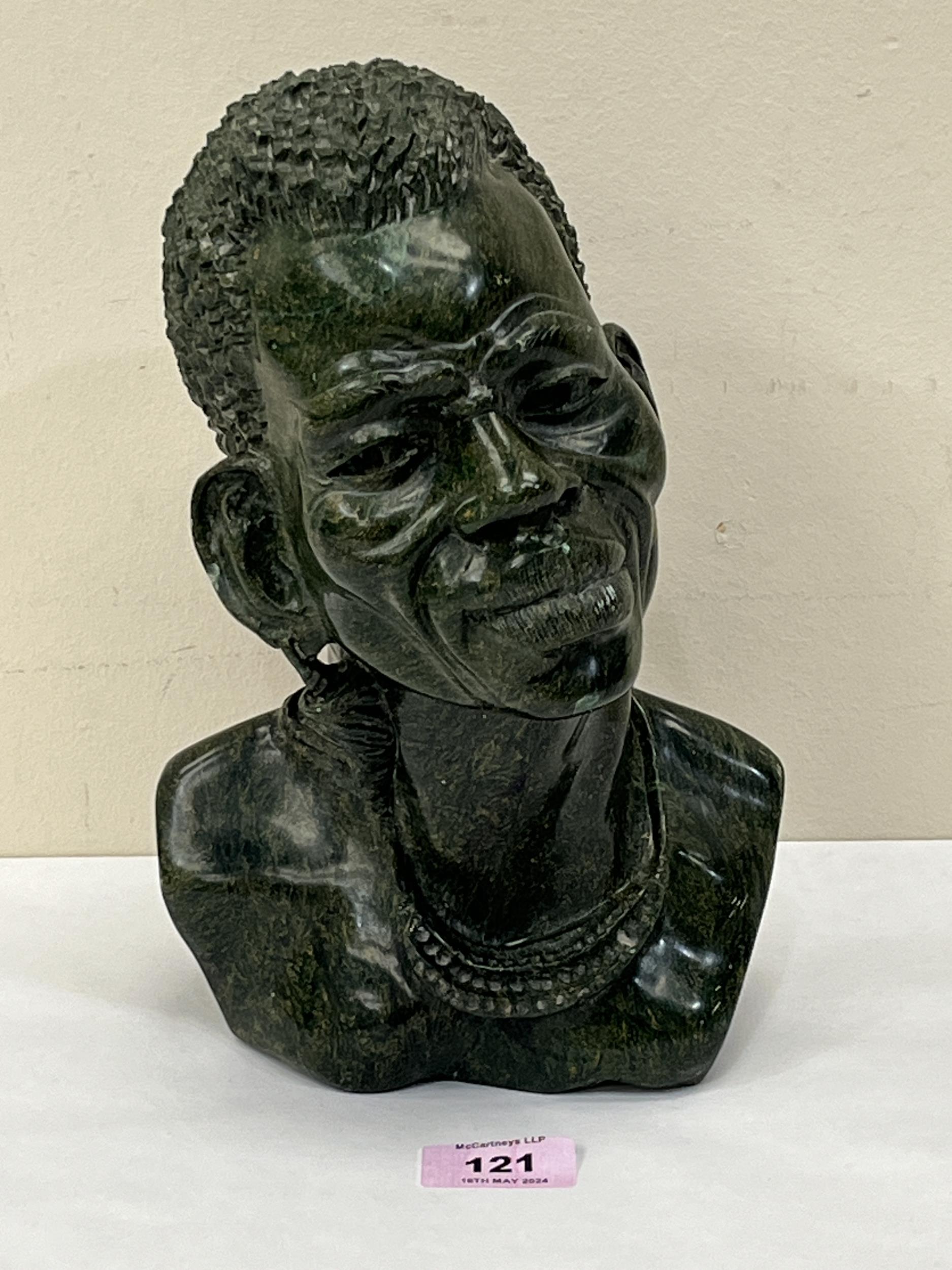 A Nigerian carved hardstone bust of a man. Signed SHADU. 10" high.