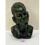 A Nigerian carved hardstone bust of a man. Signed SHADU. 10" high.