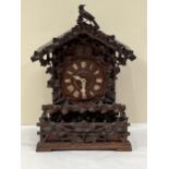 A late 19th Century Bavarian quarter striking 'Cuckoo and Quail' table clock, in chalet style oak