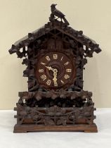 A late 19th Century Bavarian quarter striking 'Cuckoo and Quail' table clock, in chalet style oak