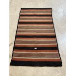 A mid 20th Century striped flat pile rug. 65" x 34½".