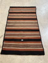 A mid 20th Century striped flat pile rug. 65" x 34½".