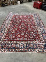 An Indian red ground carpet 138" x 96".