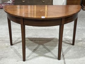 A 19th Century demi-lune side table on square tapered legs. 48" wide.