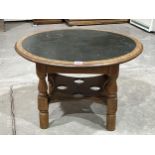 An oak low table with inlet top. 30" diam.