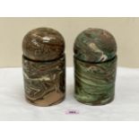 A pair of jars with globular covers, decorated with a marbled glaze in shades of green and brown.