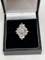 A 9ct white stone cluster ring. 3.6g gross. Size Q.