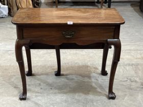 A George III mahogany drop-leaf side table, the frieze drawer with paper label stating '...