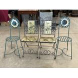 Two pairs of wrought iron patio chairs.