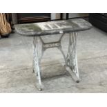 A garden table on cast iron Singer sewing machine base. 36" wide.