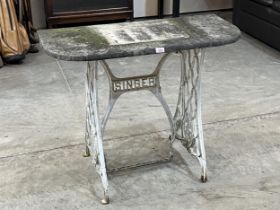 A garden table on cast iron Singer sewing machine base. 36" wide.